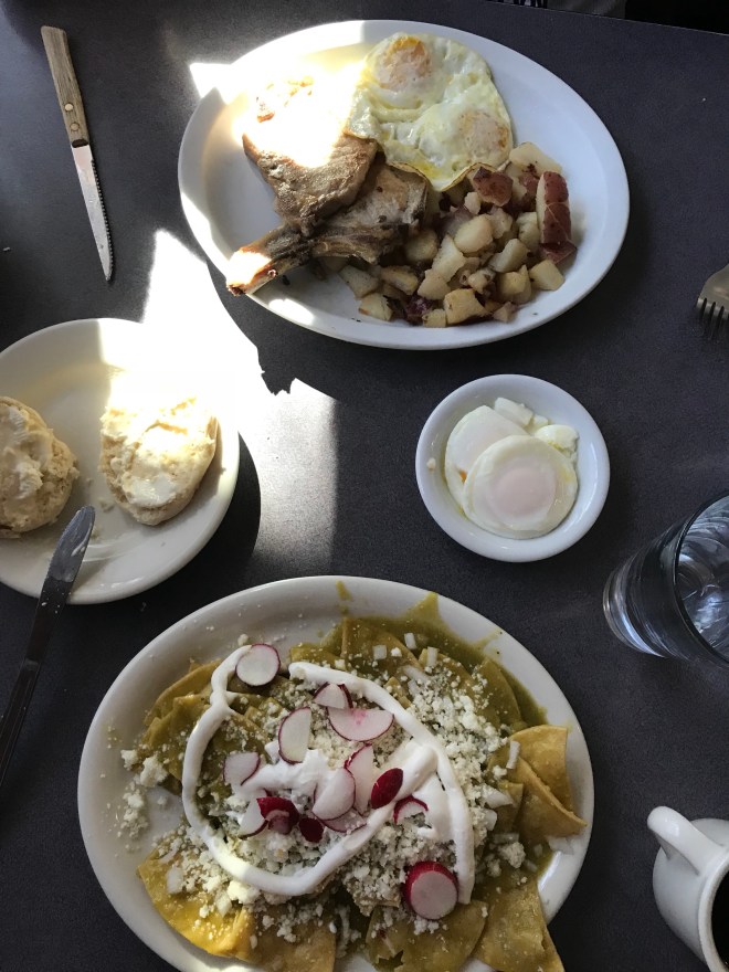 Chilaquiles, pork chops, poached eggs and a biscuit